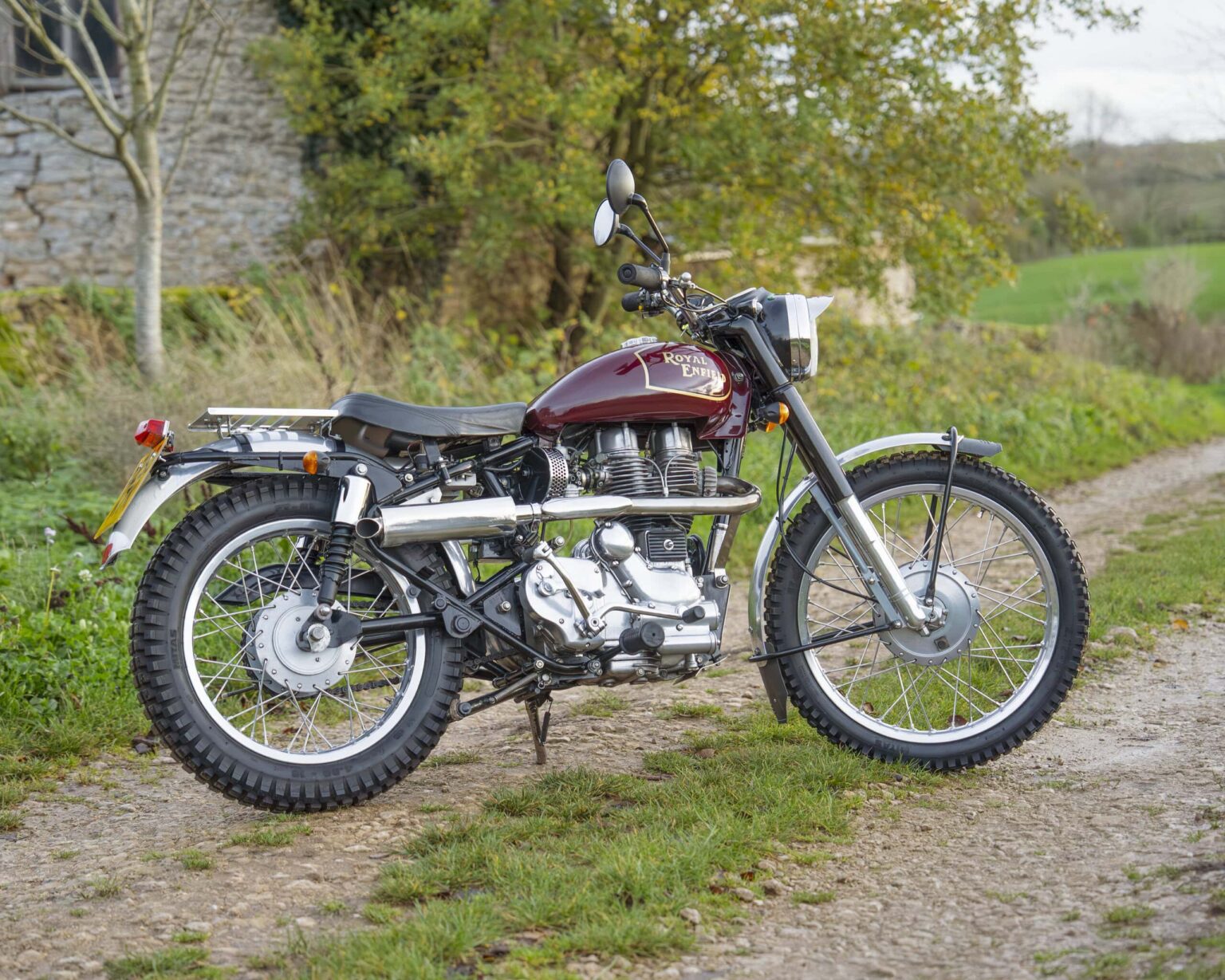 Classic motorcycle with retro design and rugged tires.