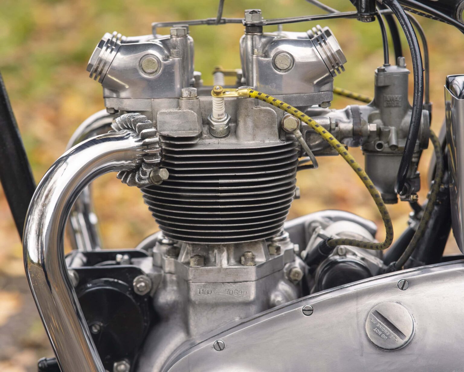 Close-up of a vintage motorcycle engine with polished metal parts and detailed components.