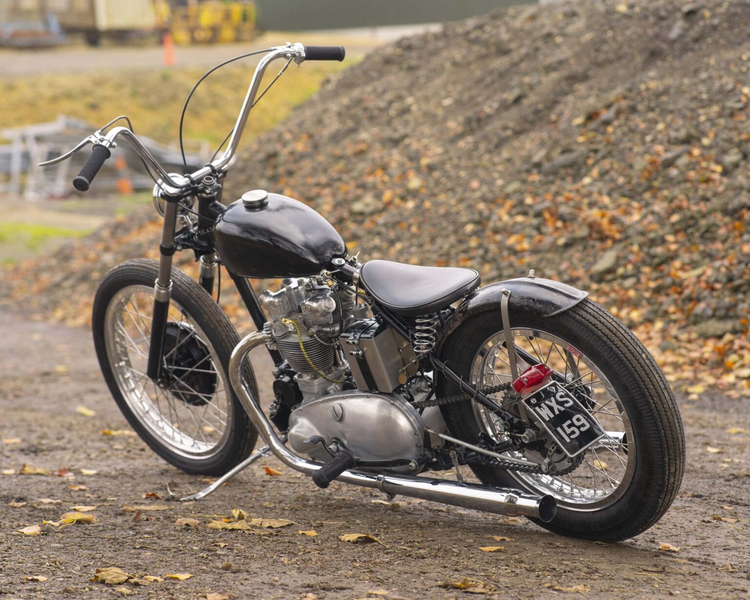 Vintage motorcycle with black and chrome finish, classic design, and retro style.
