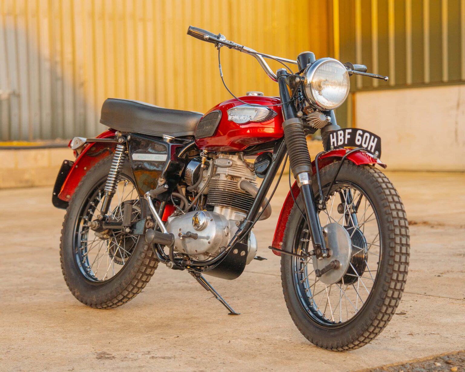 Vintage red motorcycle with black accents, ready for classic competitions.