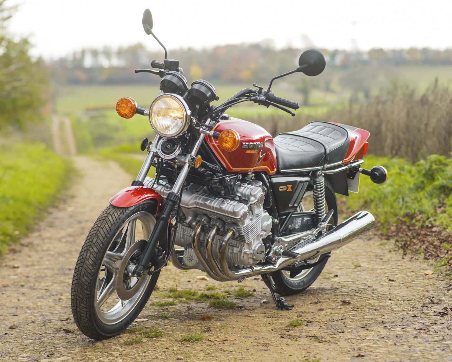 Vintage red Honda CBX on country dirt road.