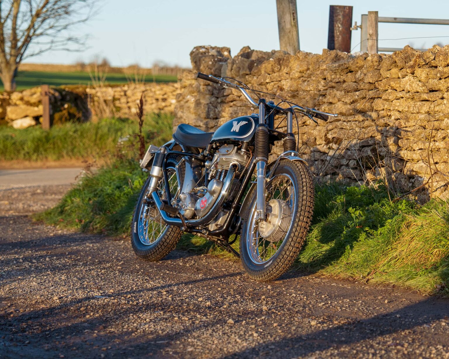 Classic British motorcycle with black paint, chrome accents, and vintage design.