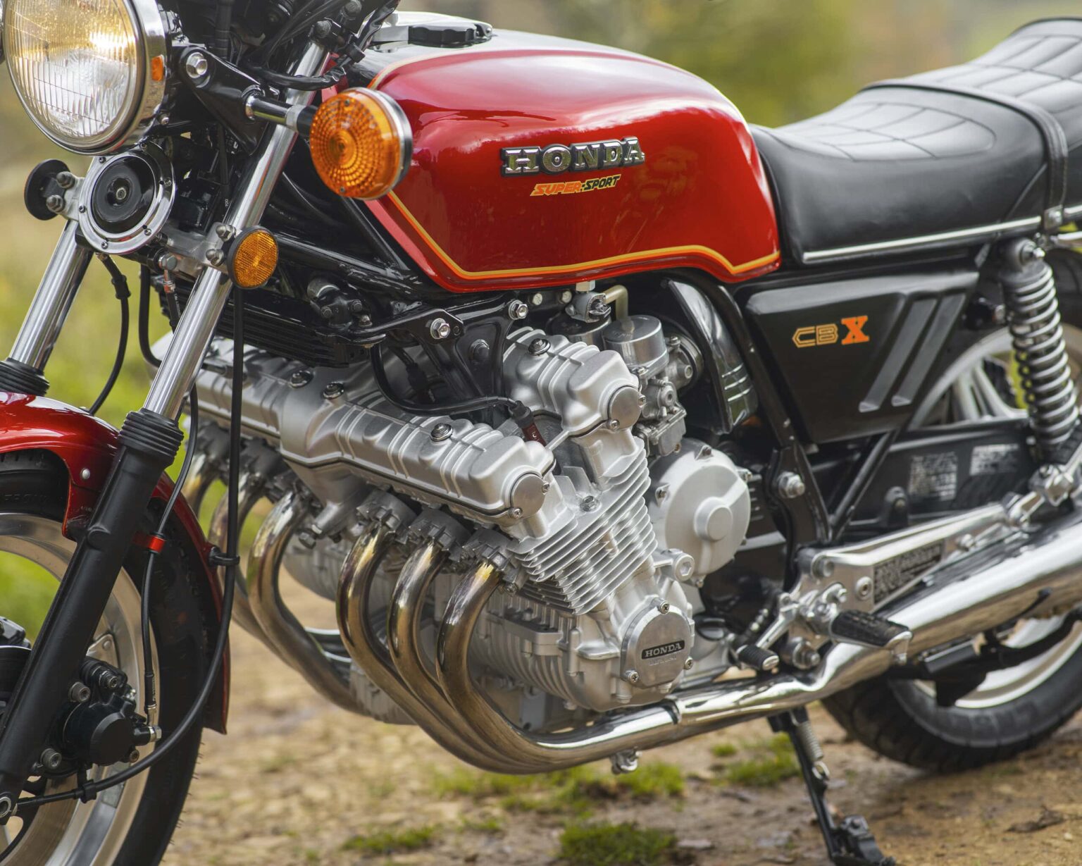 Honda CBX motorcycle engine with red fuel tank and black seat.