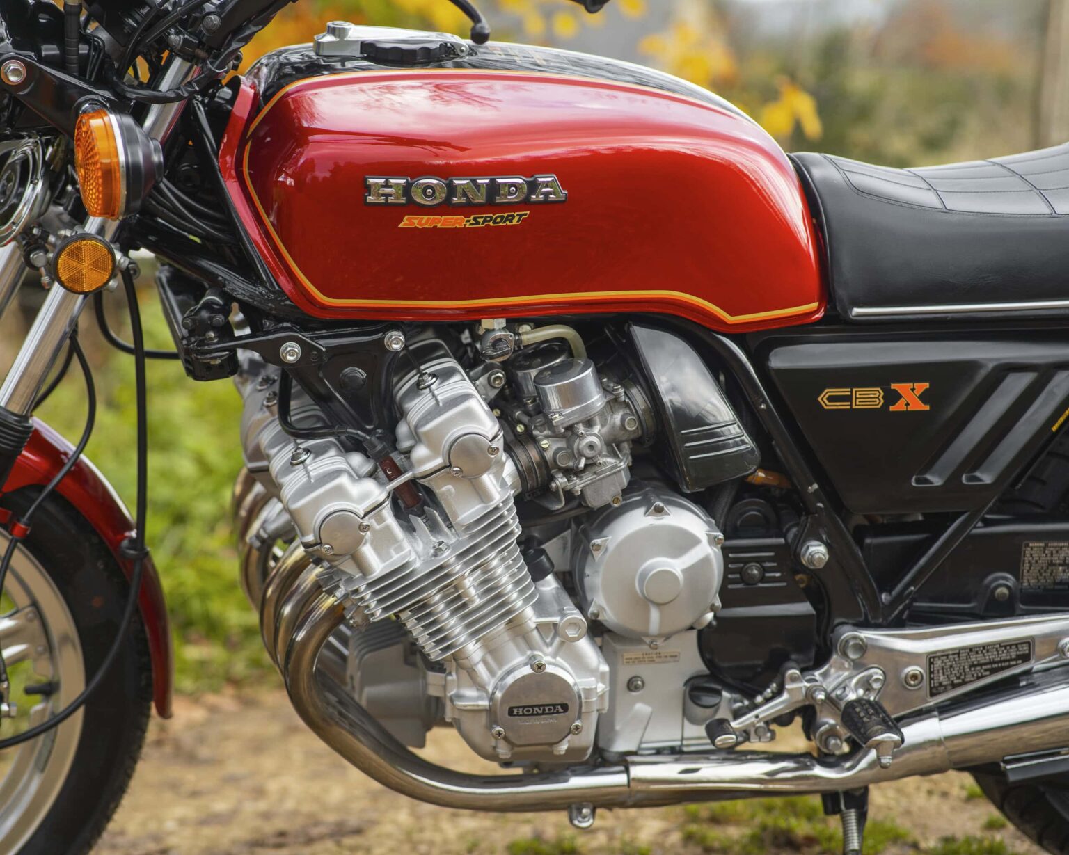 Classic Honda CBX1000 motorcycle with red fuel tank and vintage design.