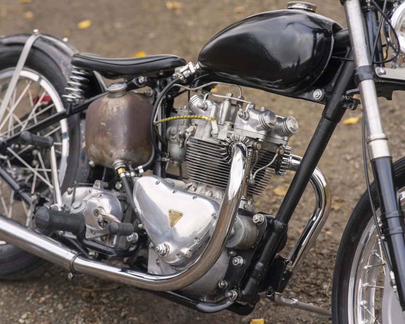 Vintage motorcycle engine with black fuel tank and chrome details.