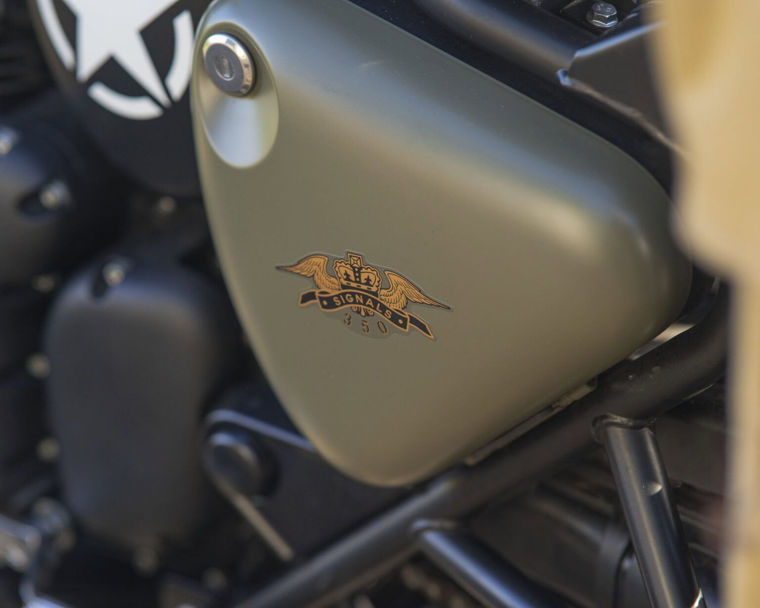Close-up of a classic motorcycle engine with vintage badge detail.