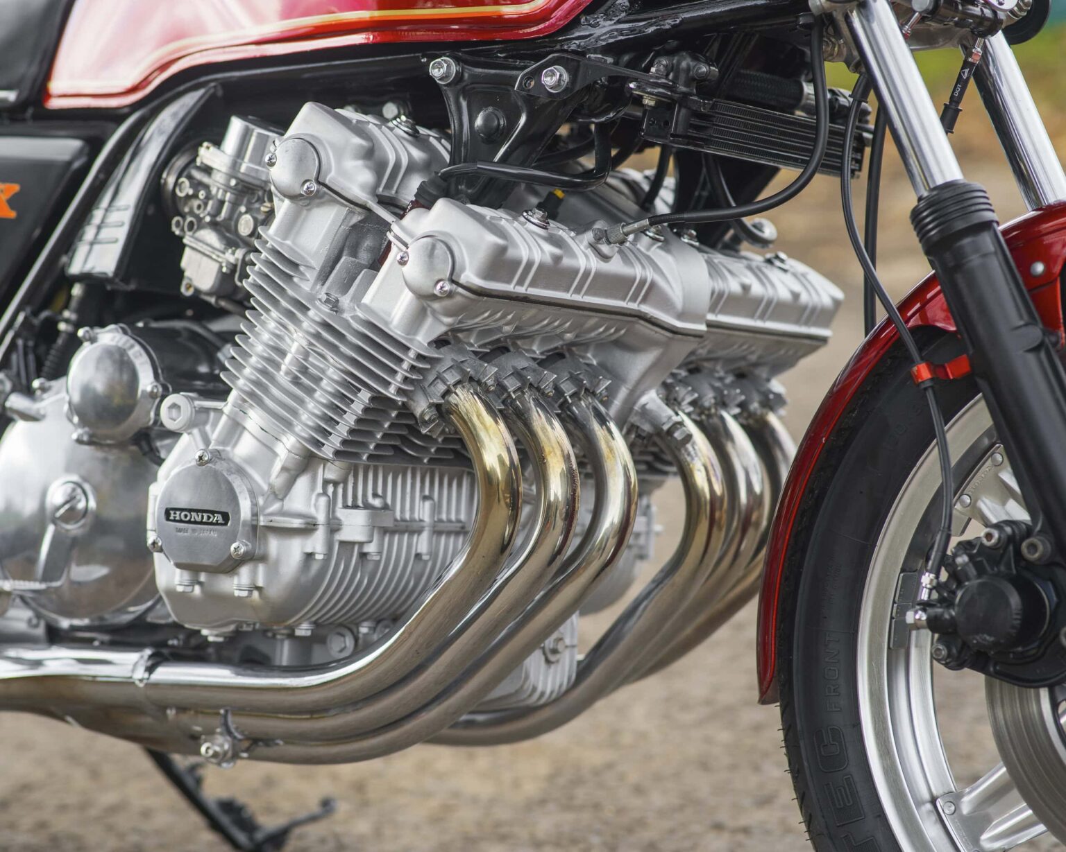 Performance Honda motorcycle engine with polished metal components and exhaust pipes.