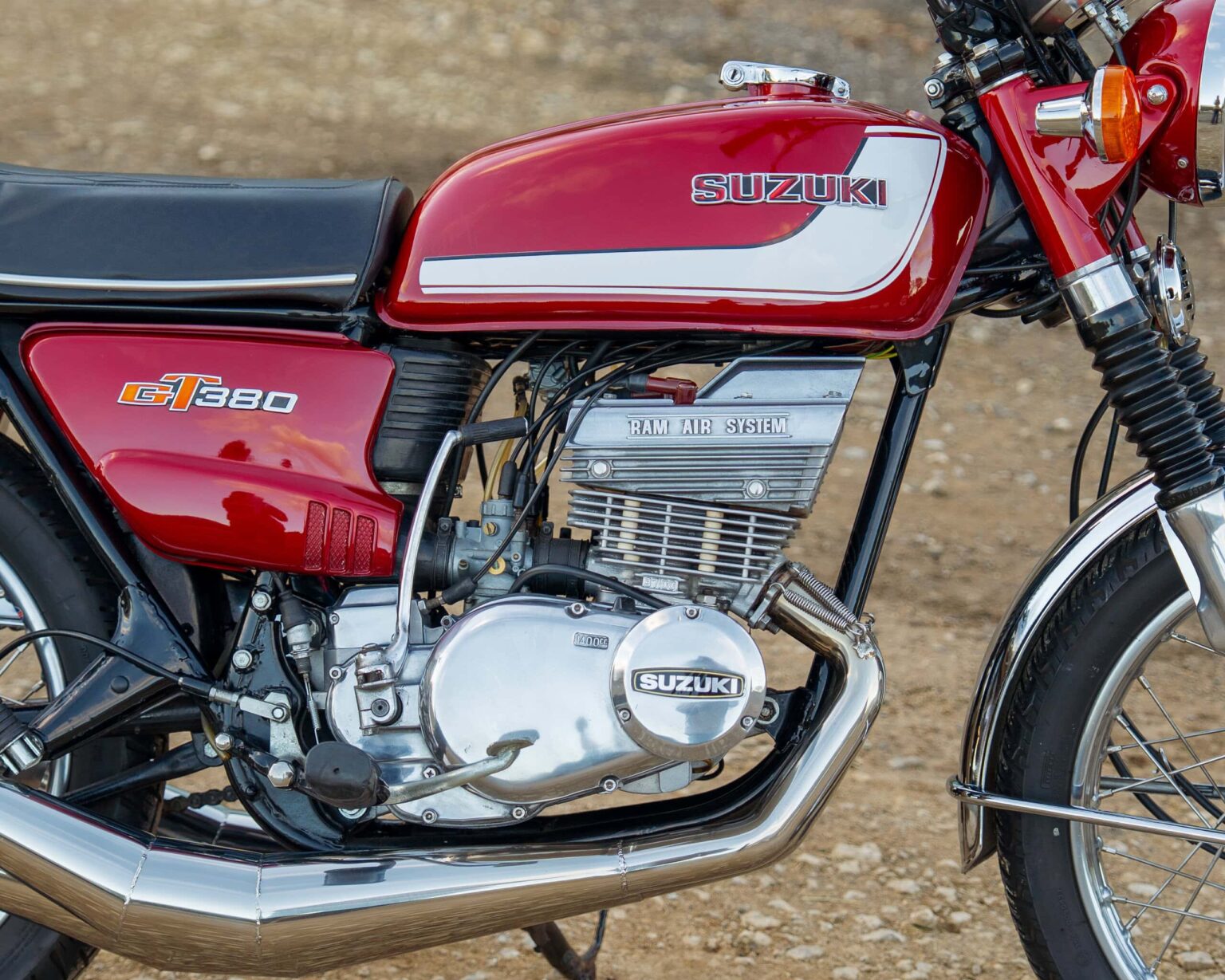 Dirt bike with red colour, vintage design, and classic Suzuki branding.