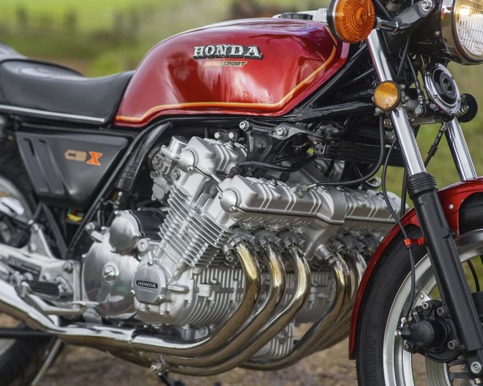 Detailed close-up of a vintage Honda CBX motorcycle engine and body, showcasing classic design and craftsmanship.