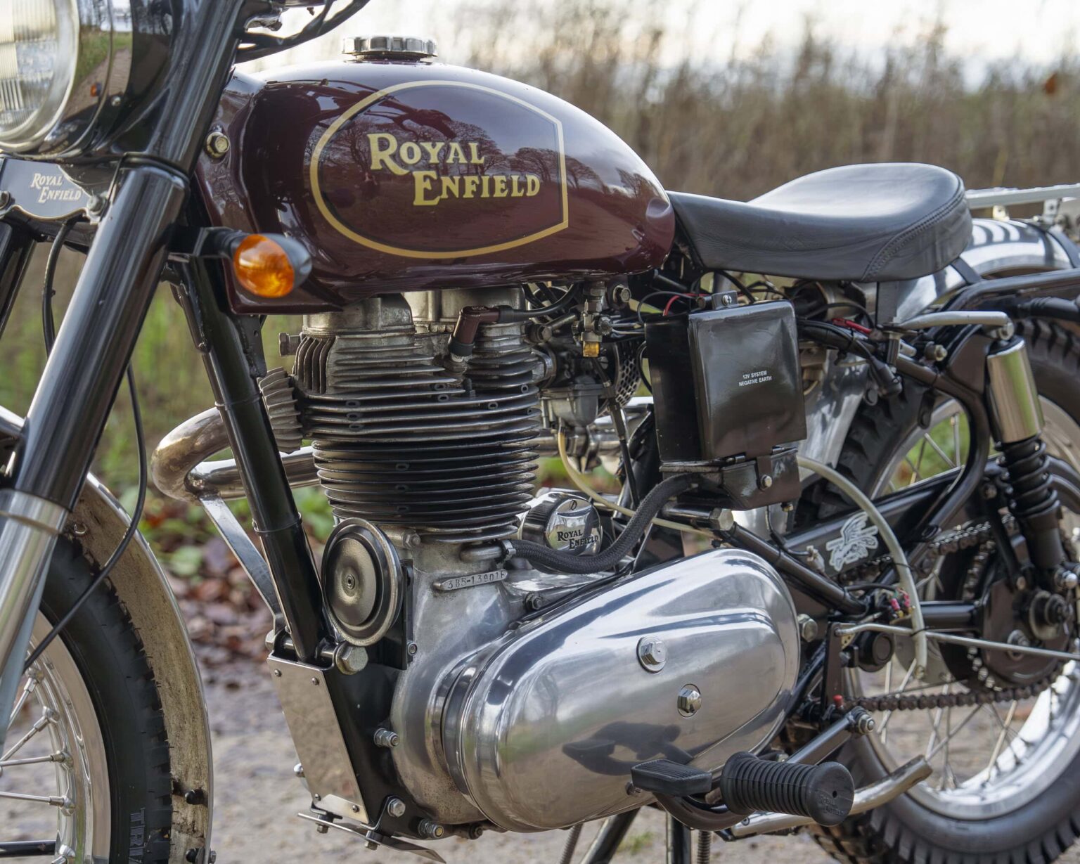 Vintage Royal Enfield motorcycle with detailed engine view.