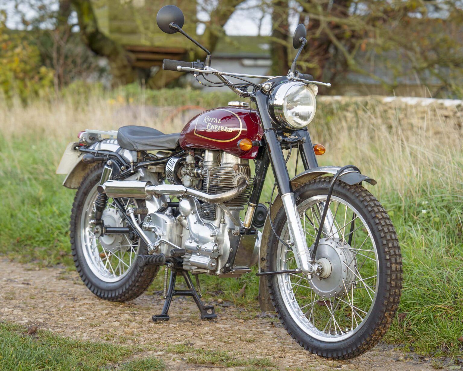 Royal Enfield vintage motorcycle on a rural path.