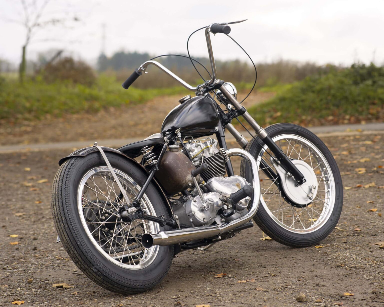Vintage custom motorcycle with a black finish and retro design. Perfect for classic bike enthusiasts.