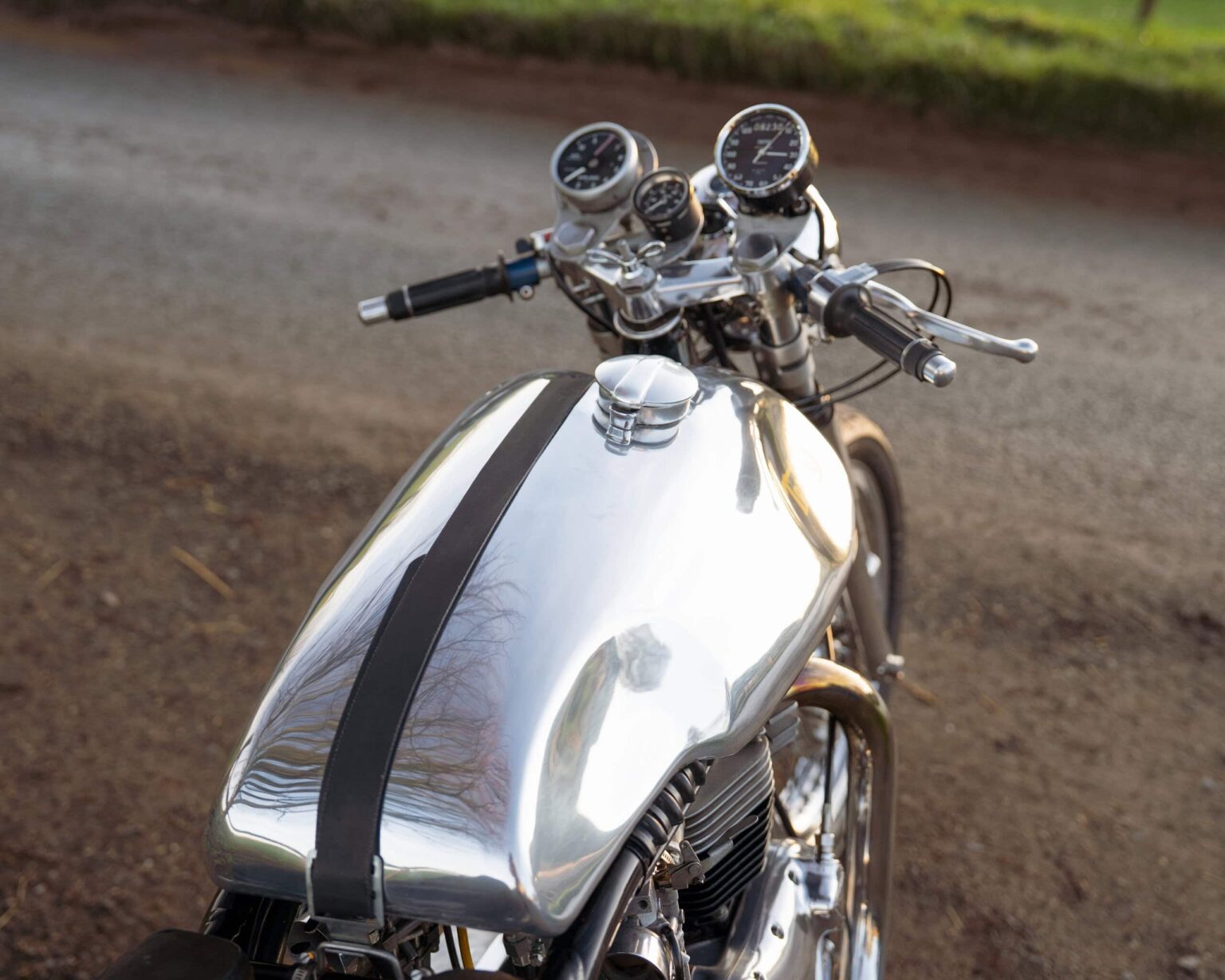 Reflective chrome vintage motorcycle on track.