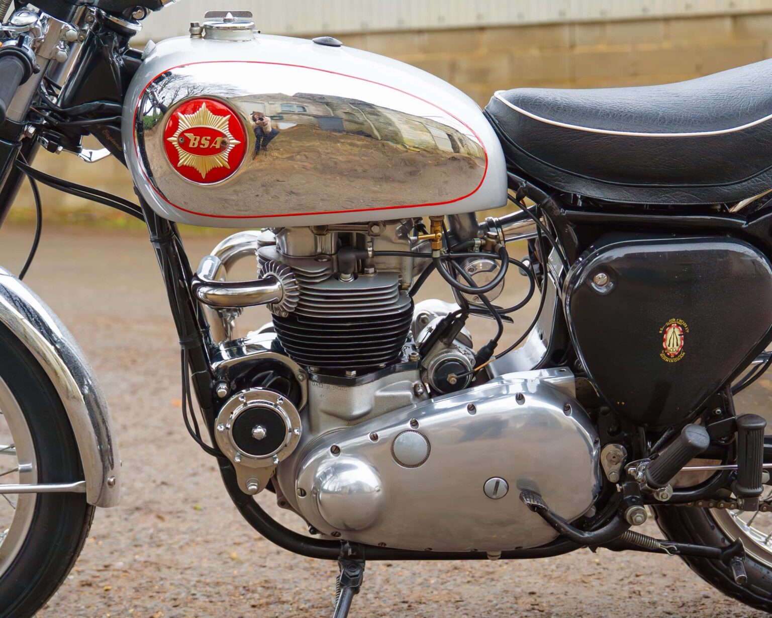 Detailed image of a vintage BSA motorcycle showing the polished engine and fuel tank with emblem.
