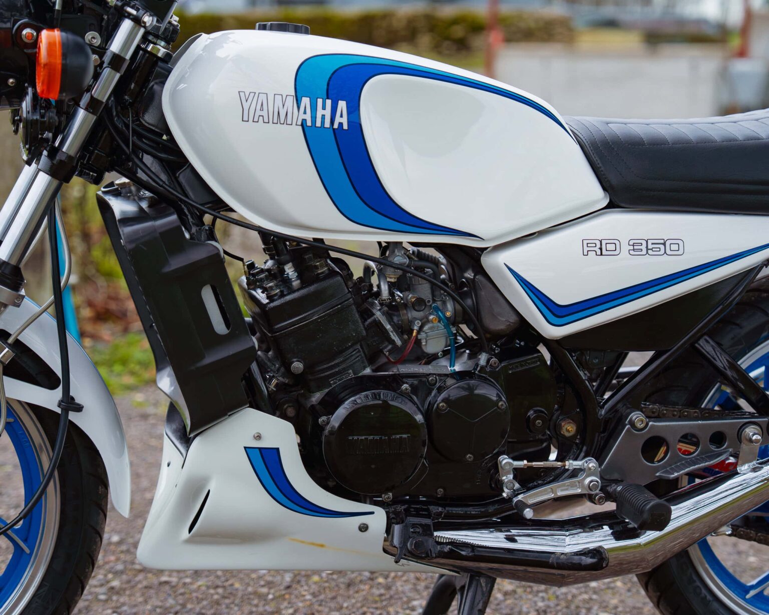 Close-up of classic Yamaha RD 350 motorcycle with racing modifications.