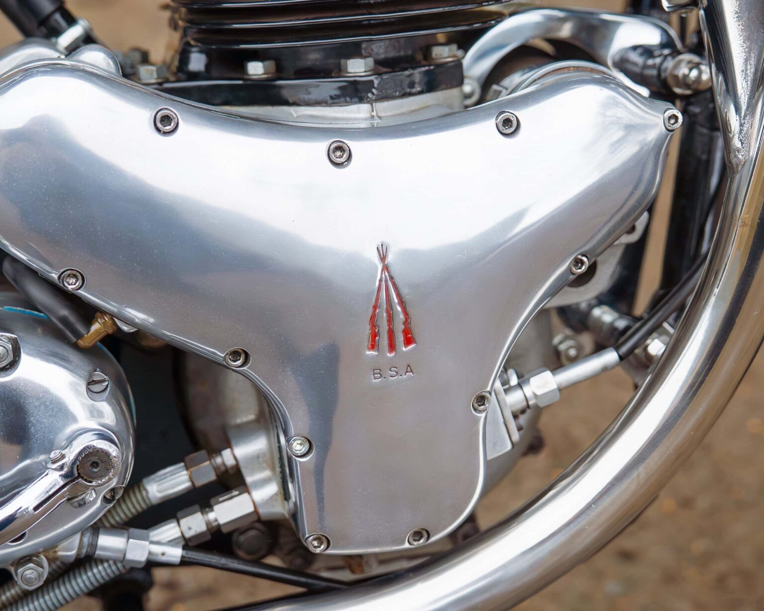 Close-up of vintage motorcycle engine with polished metal components and B.S.A emblem.