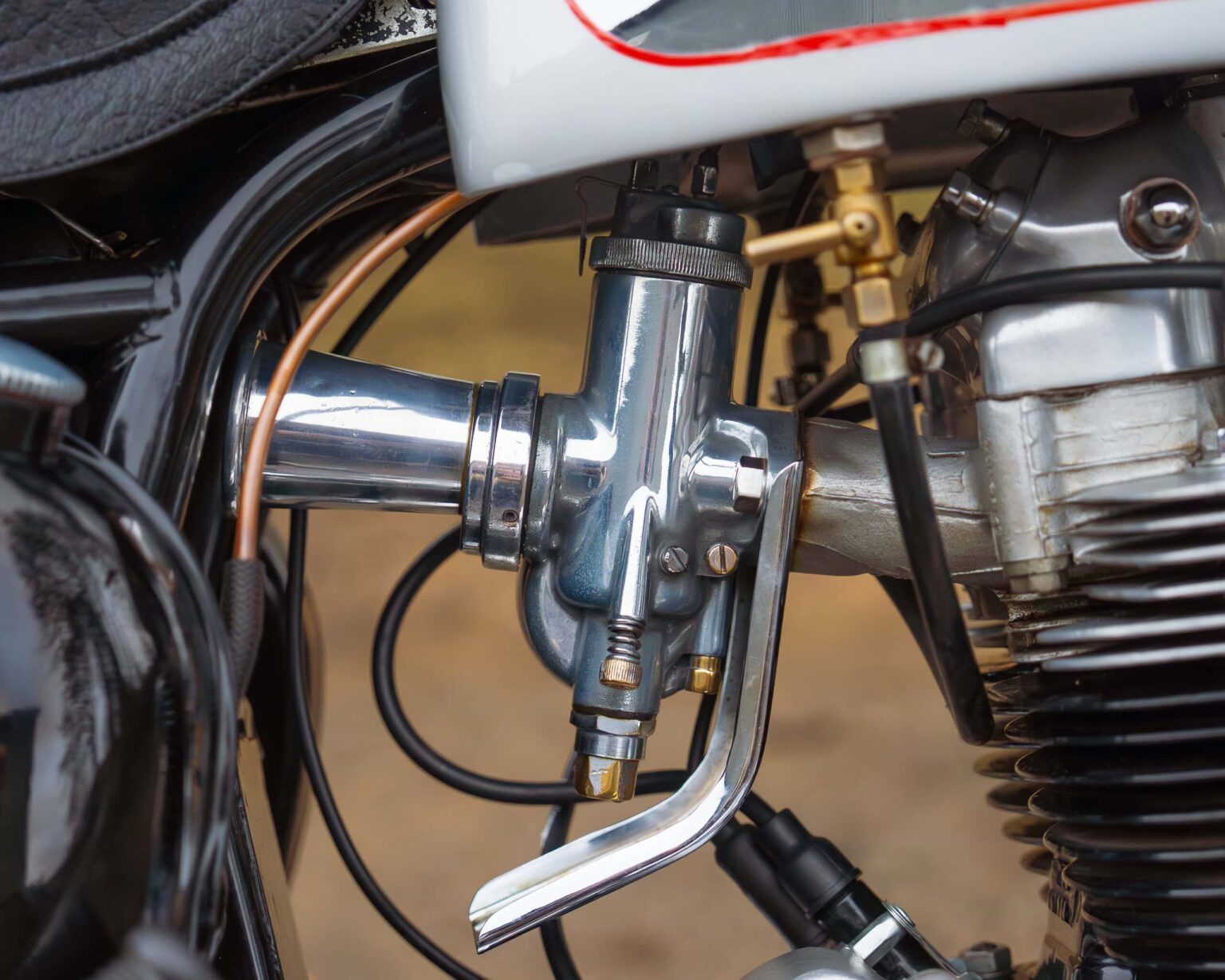 Close-up of vintage motorcycle engine and handlebar details at Classic Competition Company.