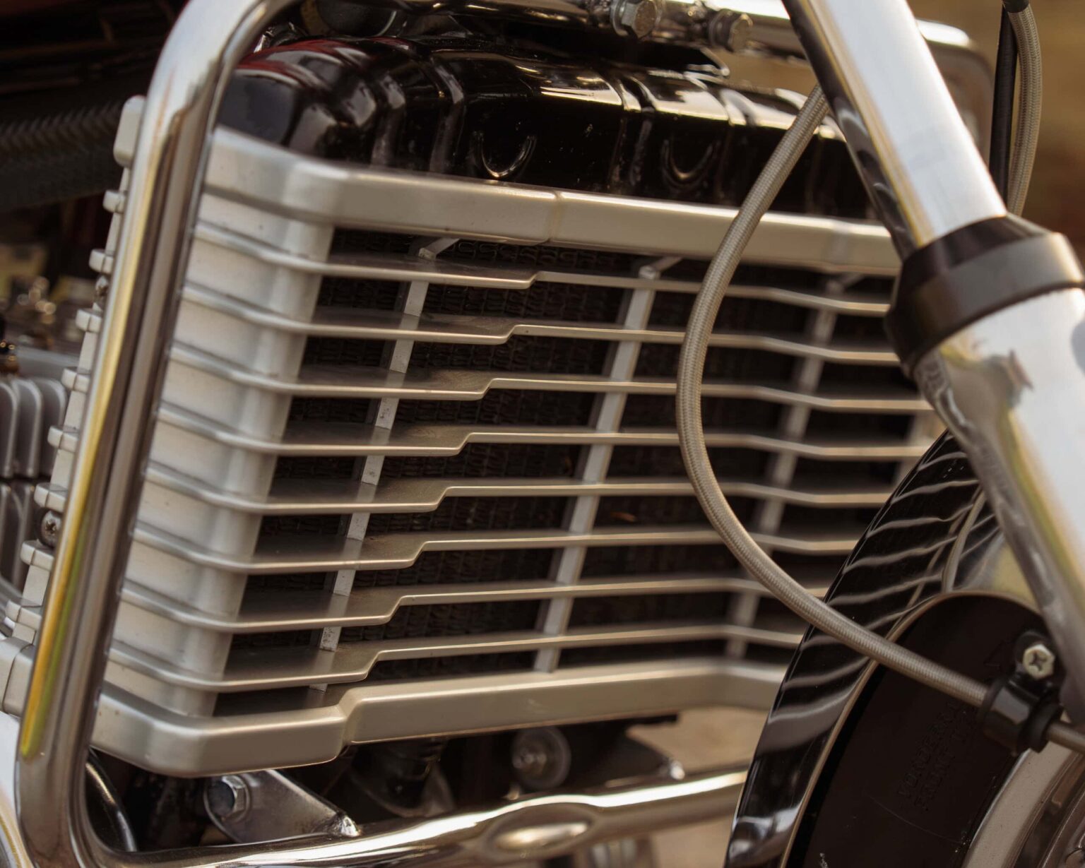 Detailed image of a vintage motorcycle engine's cooling fins and chrome accents at the Classic Competition event.