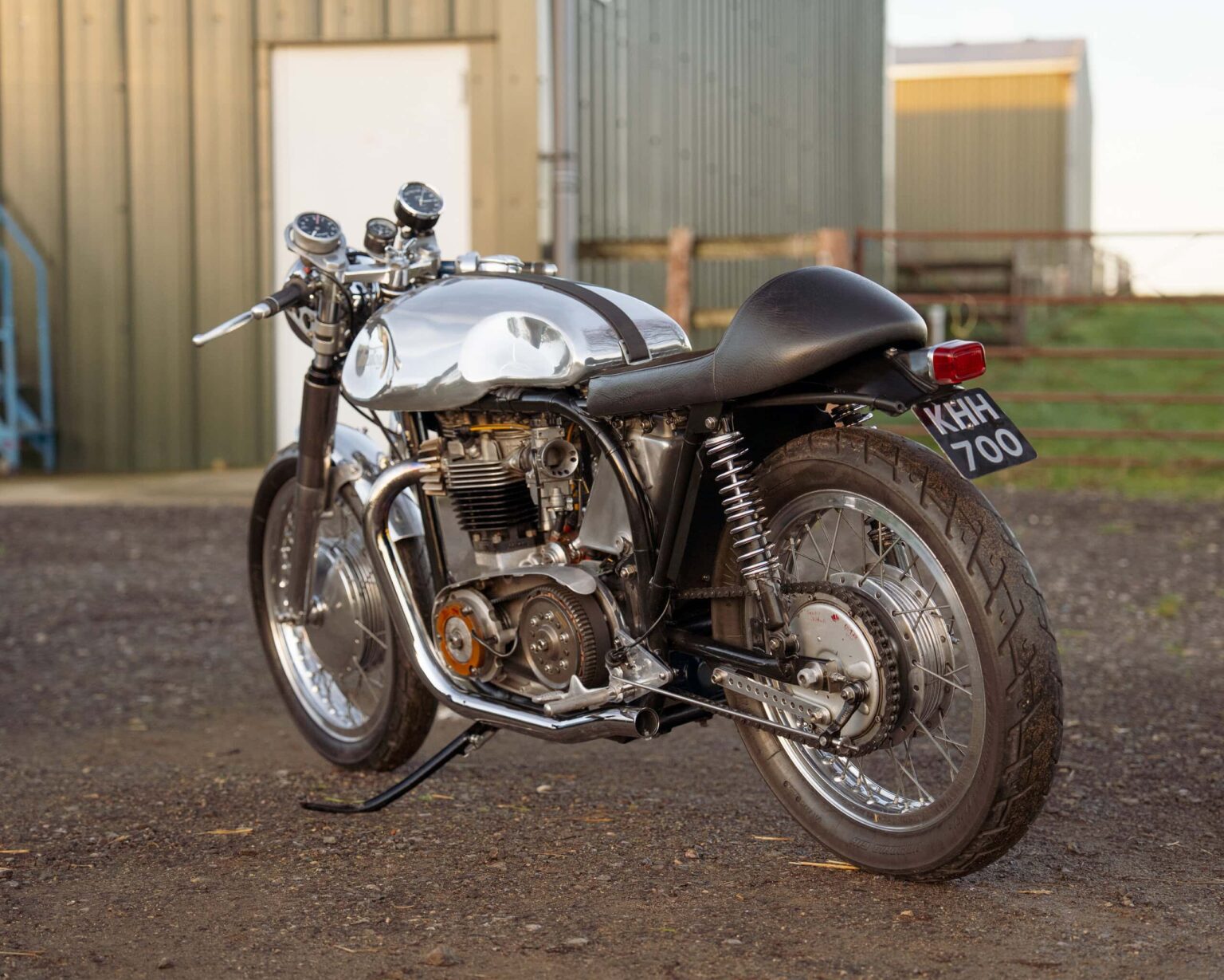 Vintage customised motorcycle with chrome finish and black seat, ideal for racing events.