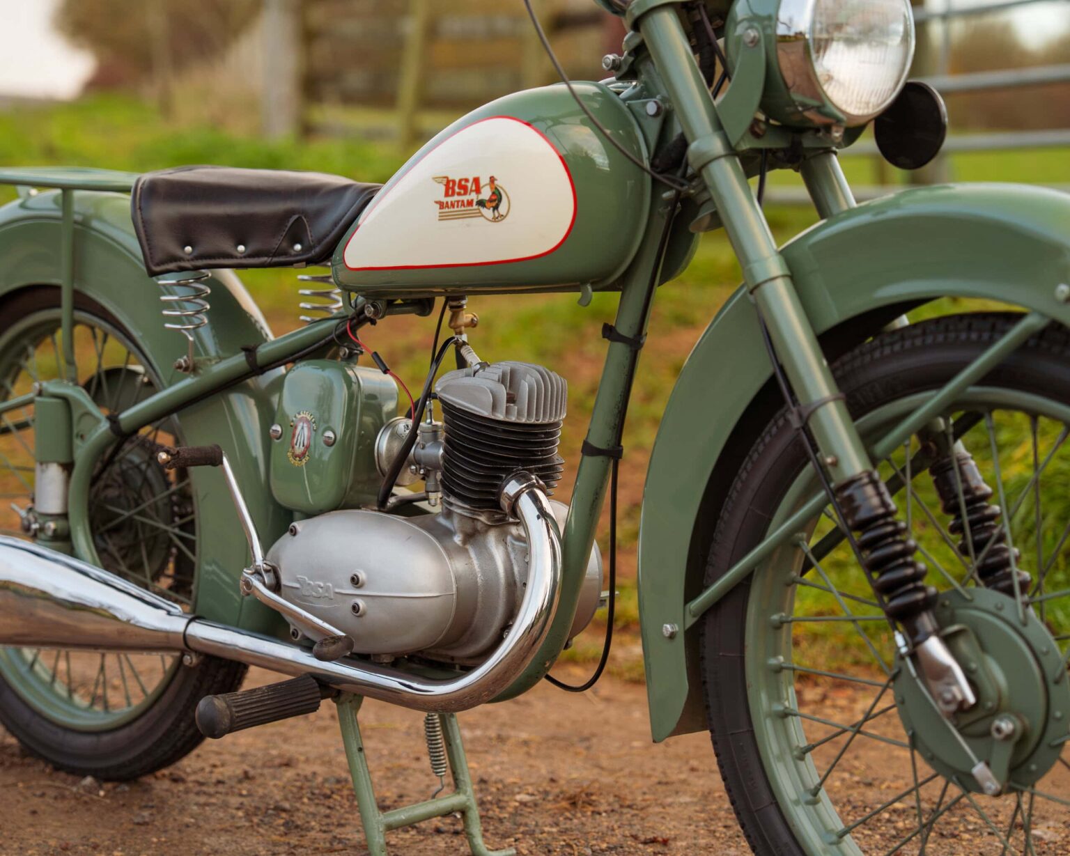 An antique green motorcycle with a BSA logo, vintage design, and classic features.