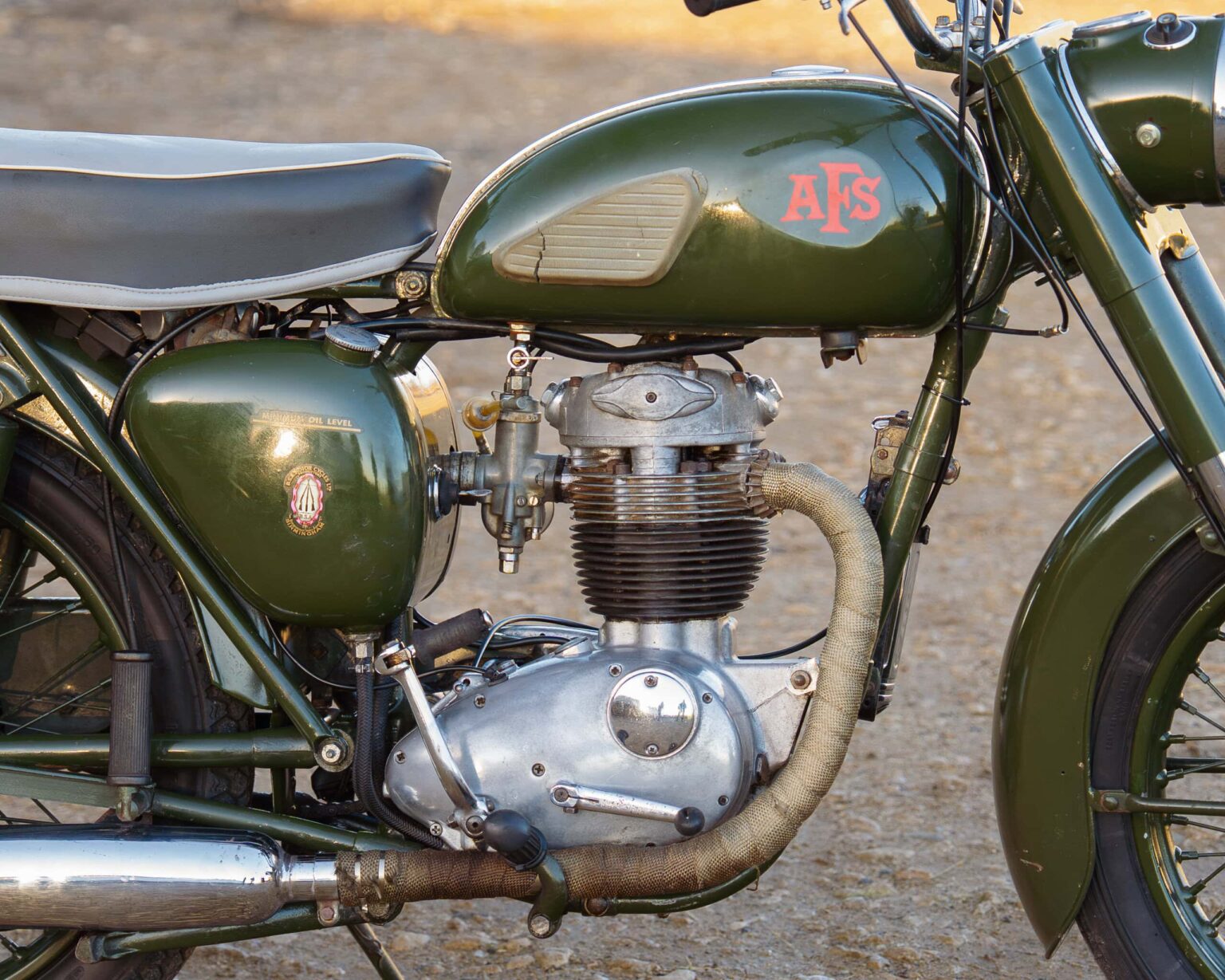 AJS vintage motorcycle engine with classic design and green fuel tank.