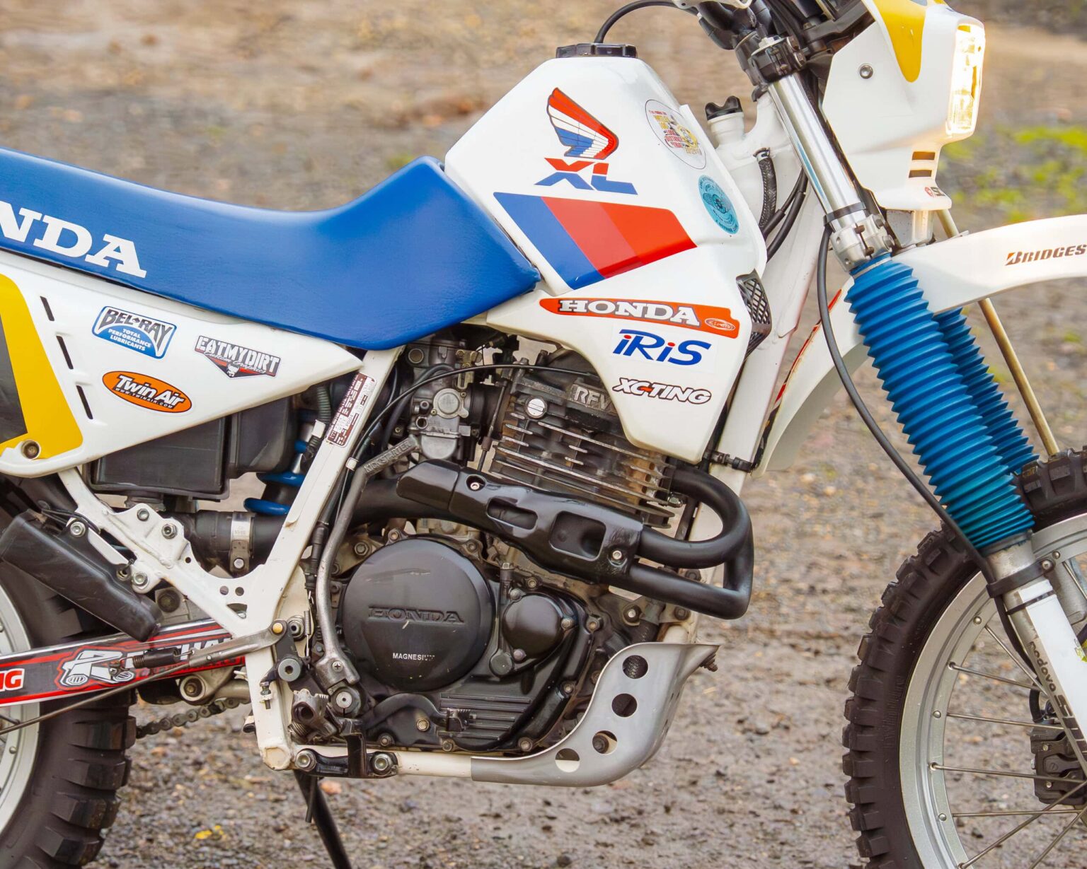Vintage Honda XR dirt bike with racing decals and sturdy build for classic motorcycle competitions.
