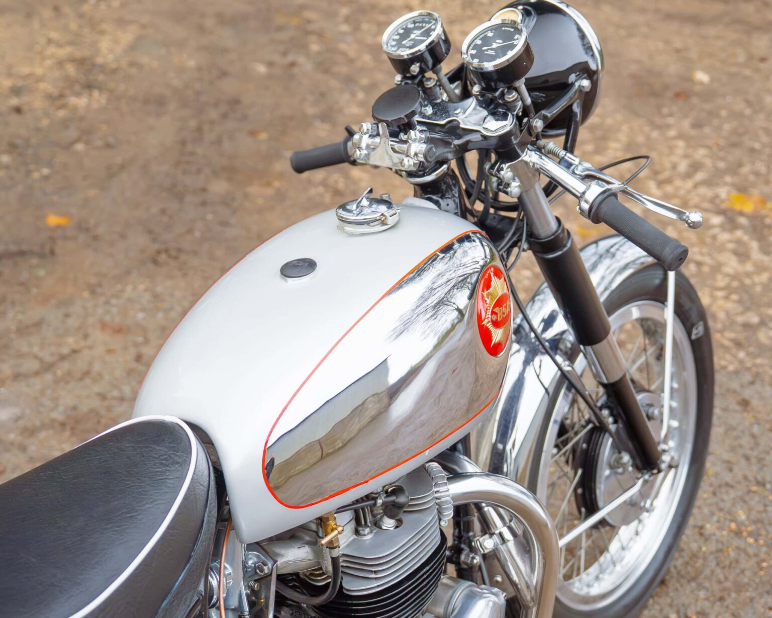 Retro motorcycle with chrome tank and vintage racing features for classic motorcycle competitions.