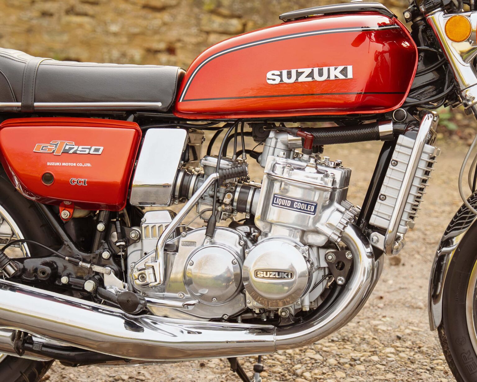 High-resolution close-up of a vintage Suzuki GT750 motorcycle highlighting the engine and classic design.