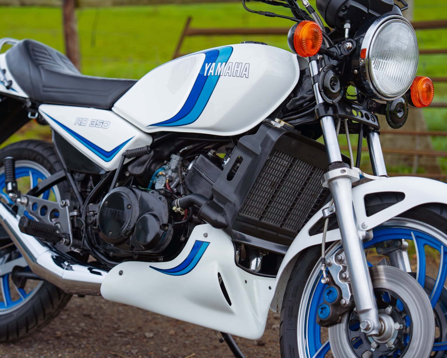 Close-up of a Yamaha RD 350 motorcycle during a classic racing event, highlighting its vintage appearance and detailed features.