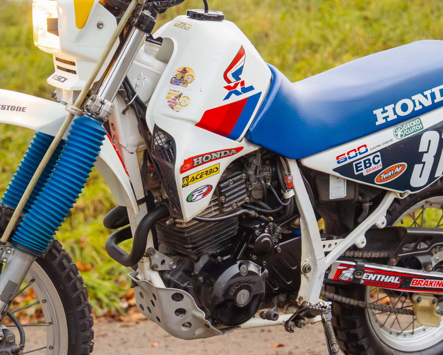 Honda CRF motocross bike with racing decals and suspension.