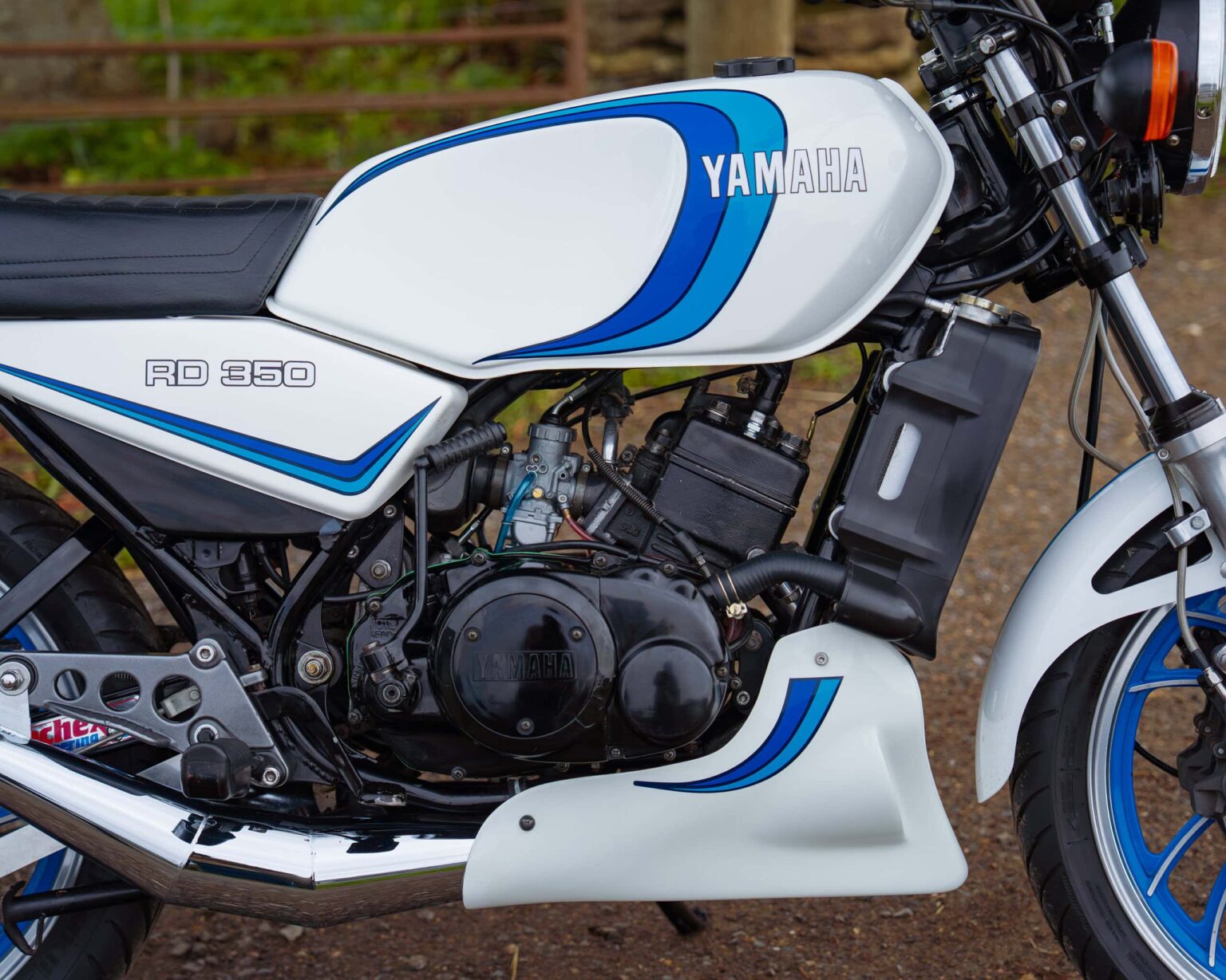 Close-up of a classic Yamaha RD 350 motorcycle with vintage design and performance features for racing.
