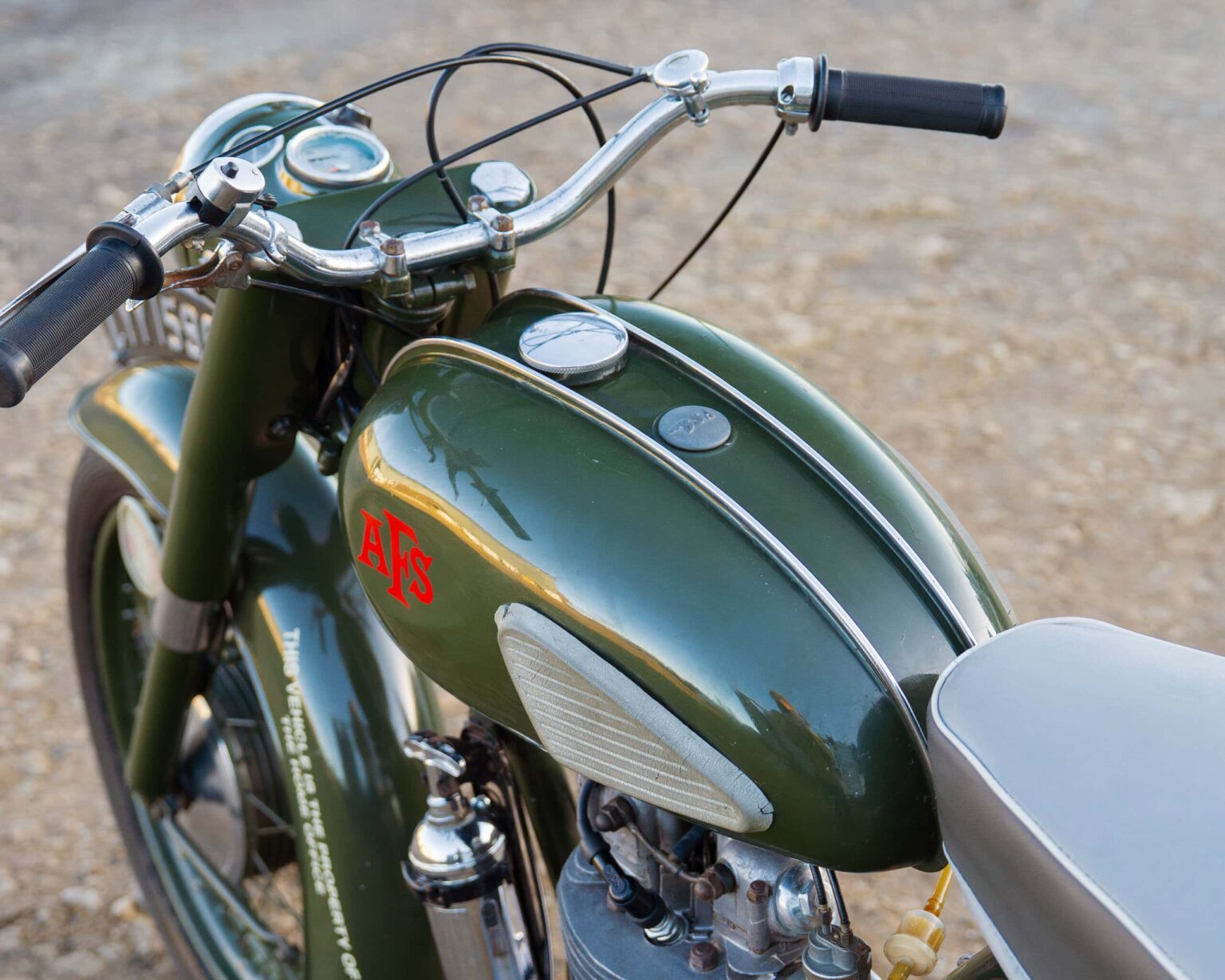 Vintage motorcycle with green paint and chrome details.