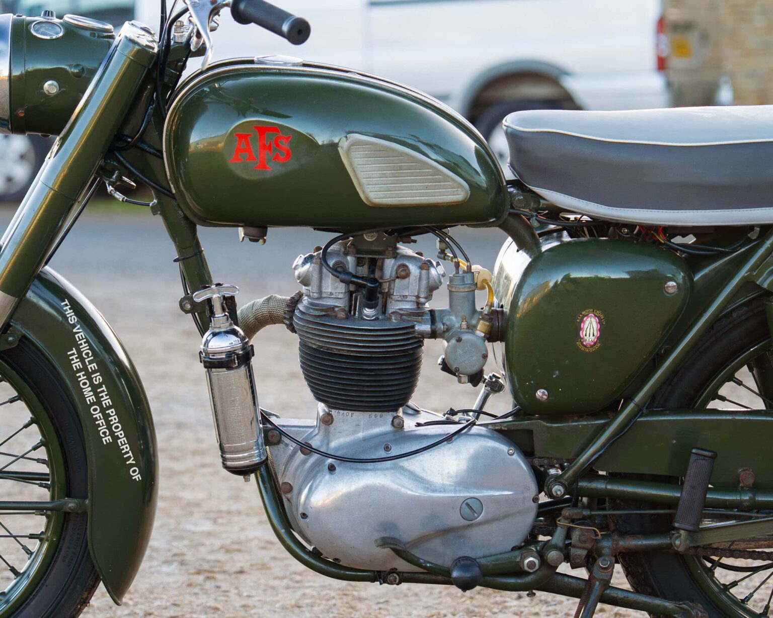 Vintage green motorcycle with AFS logo and classic engine details.