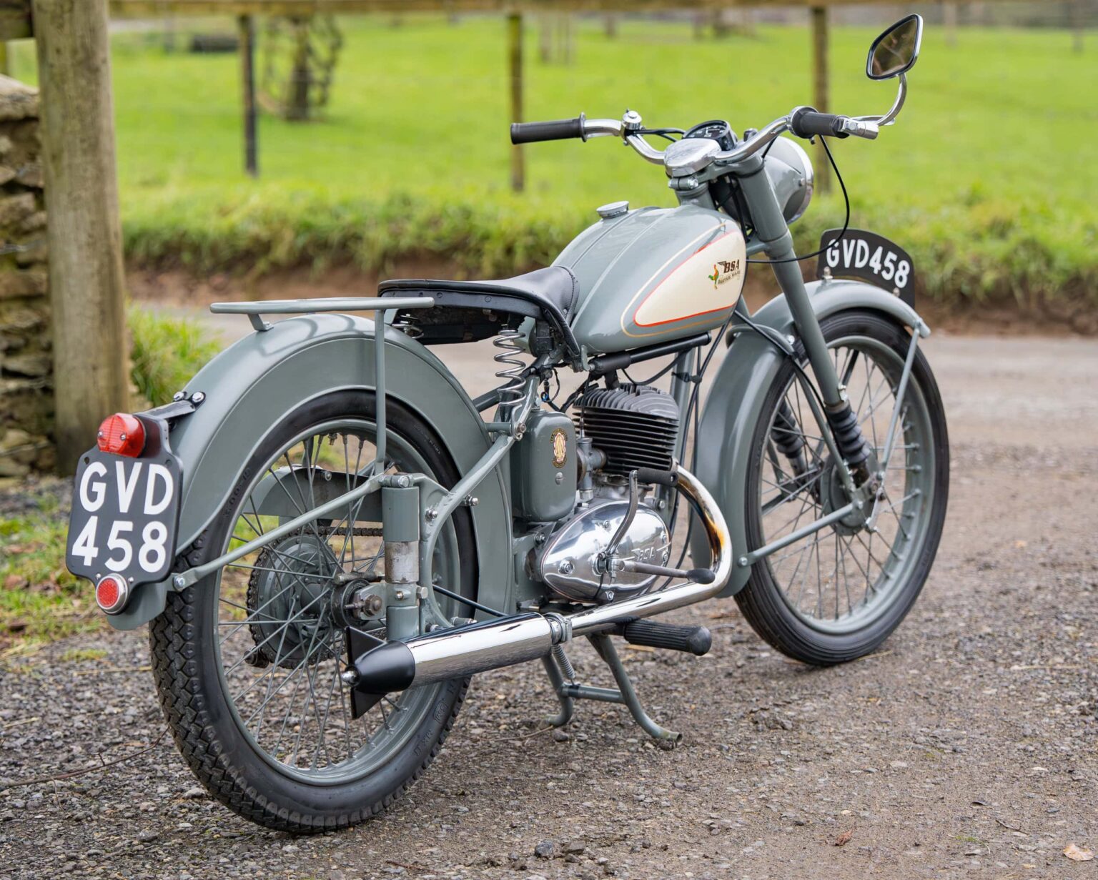 Vintage motorcycle with grey paint and classic design.