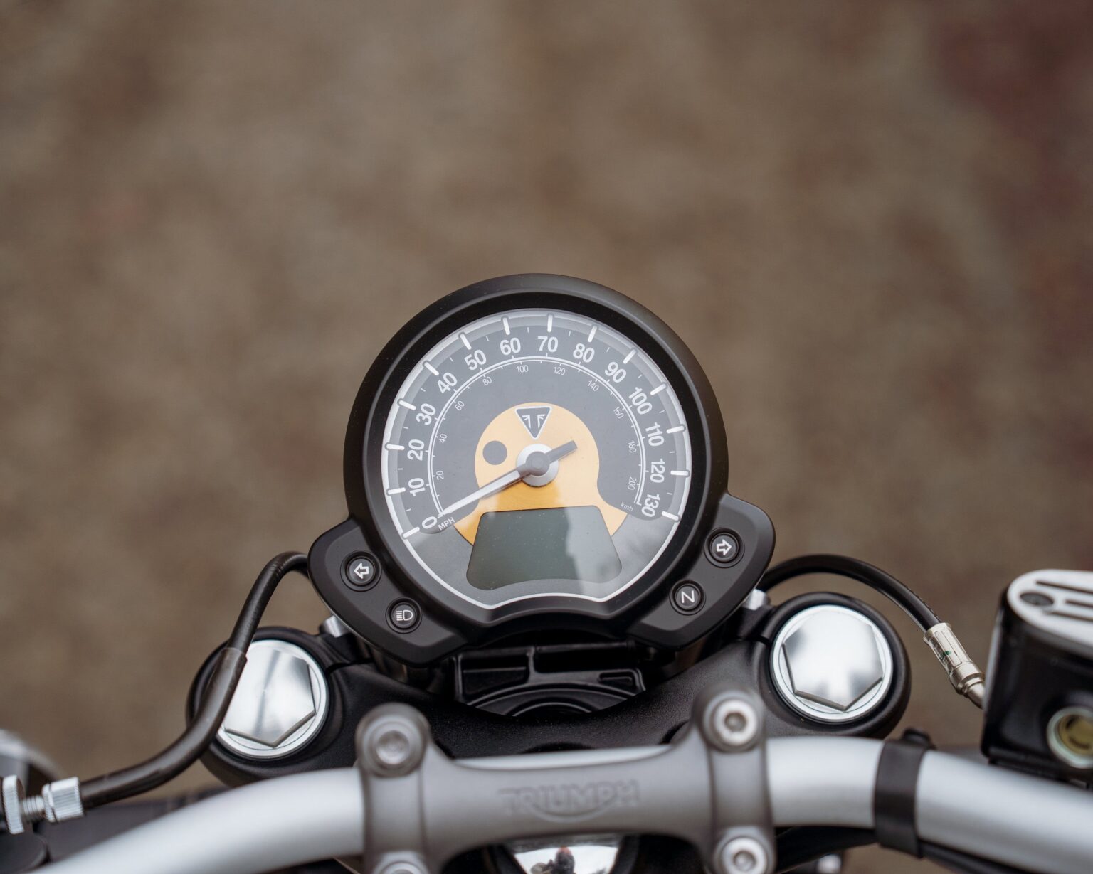 Motorcycle speedometer with digital display and analog dial.