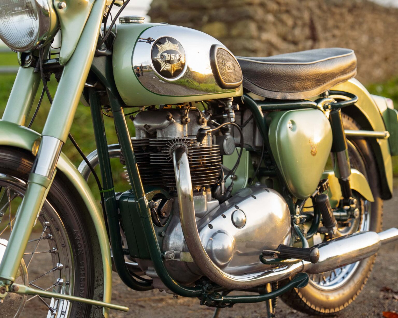 Vintage motorcycle with a green and chrome finish.