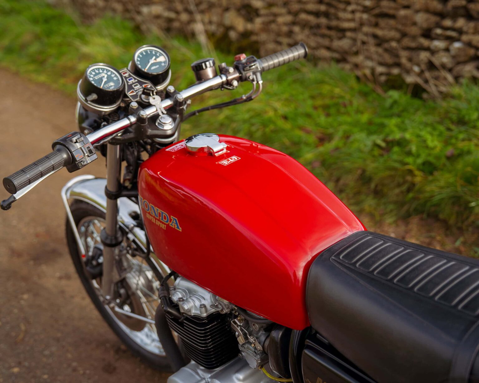 Vintage Honda CB750 motorcycle parked on a country road.