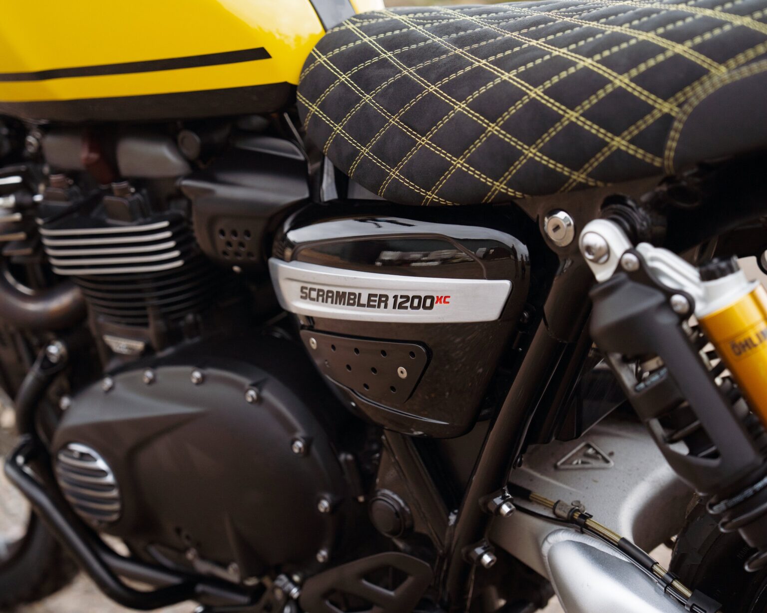 Motorcycle engine with "Scrambler 1200 XC" branding in detail.