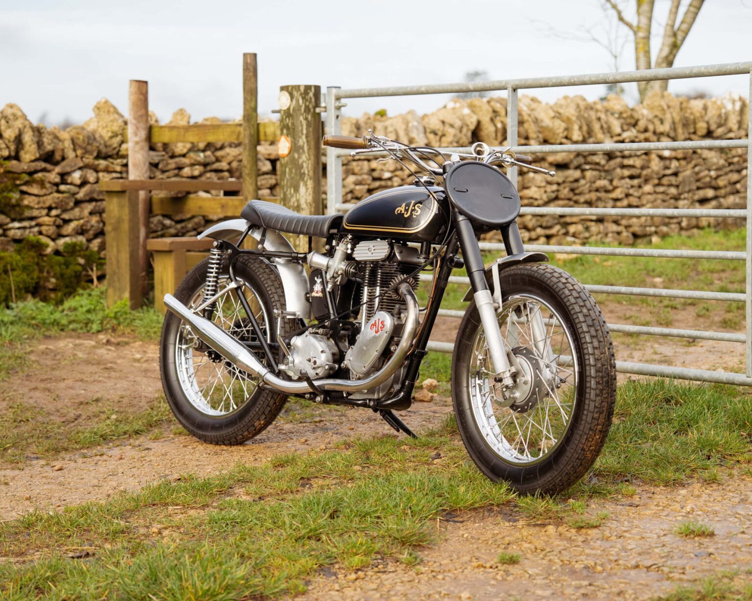 Vintage motorcycle with black and chrome finish parked outdoors.