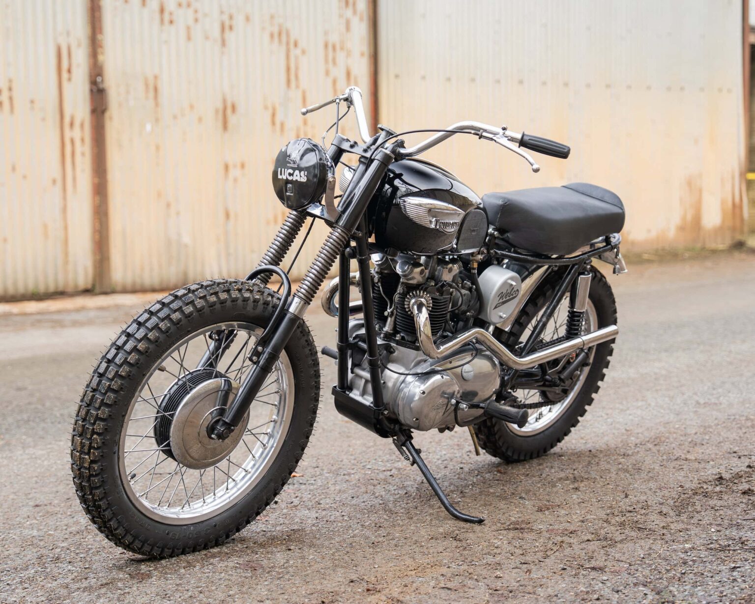 Vintage black motorcycle with rugged tyres and chrome details.