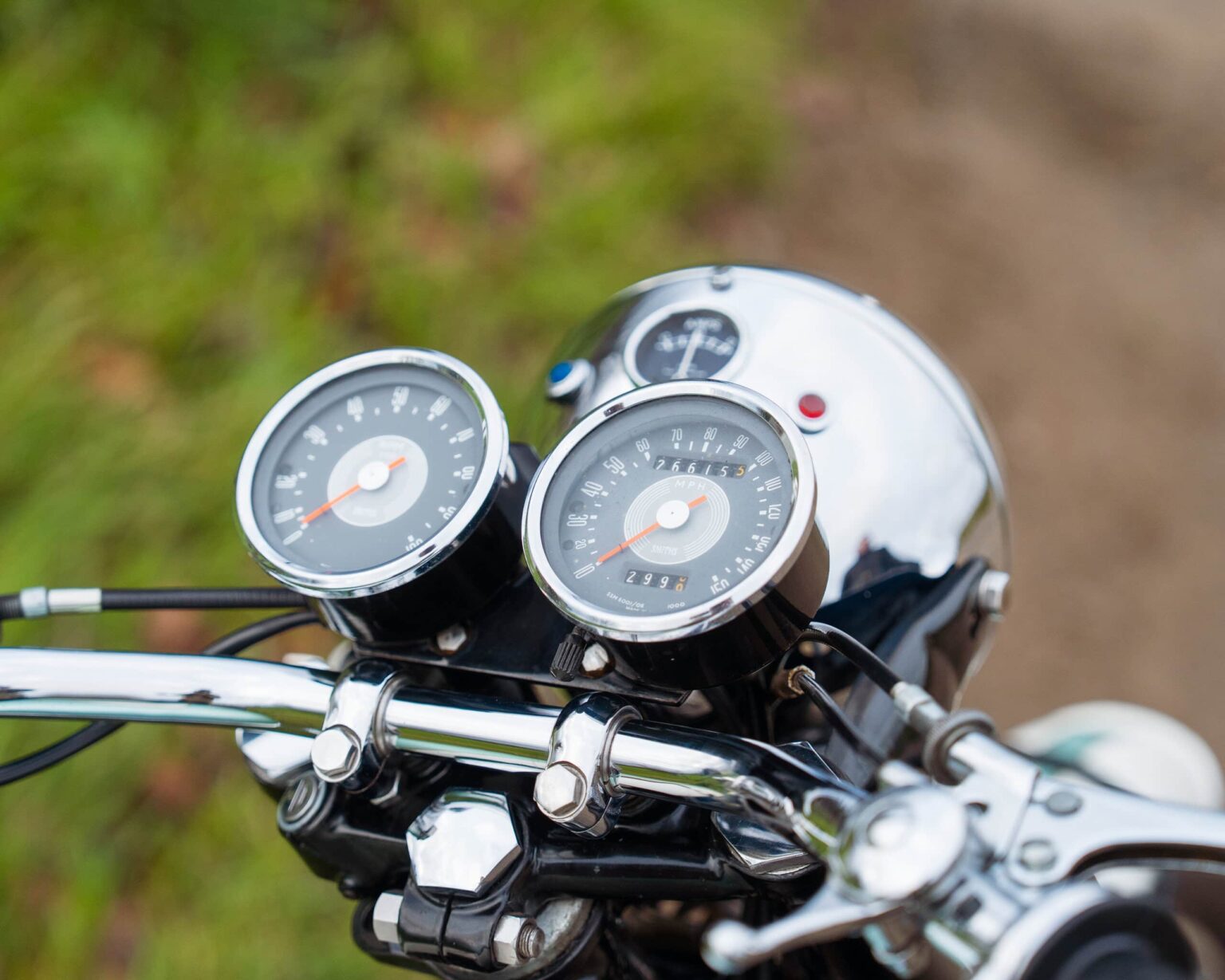 Motorcycle speedometer and tachometer gauges on the handlebar.