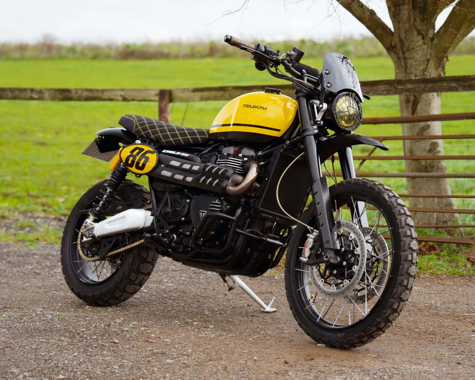 Bright yellow off-road motorcycle with black accents and rugged tires.