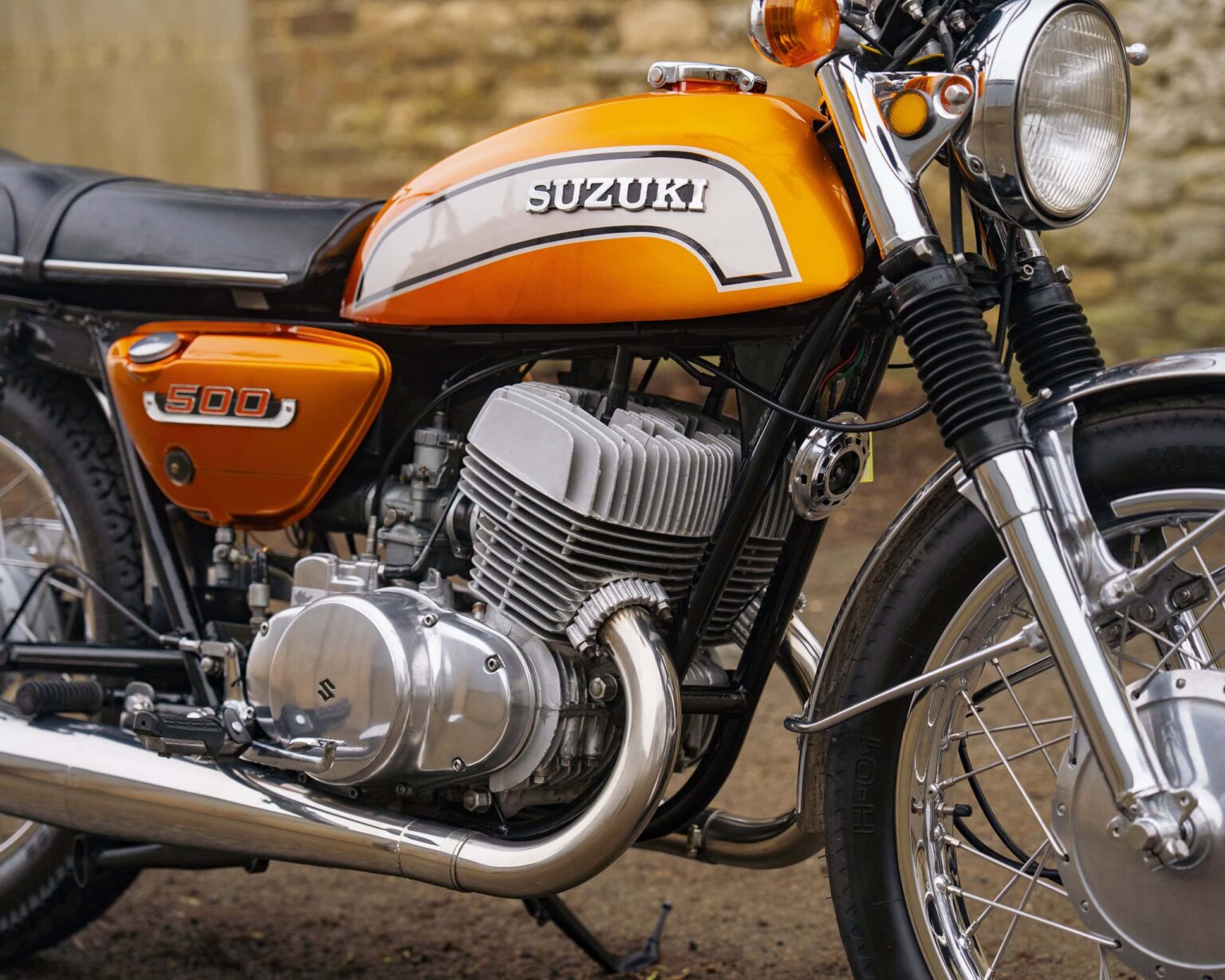 Vintage orange Suzuki 500 motorcycle with black accents.