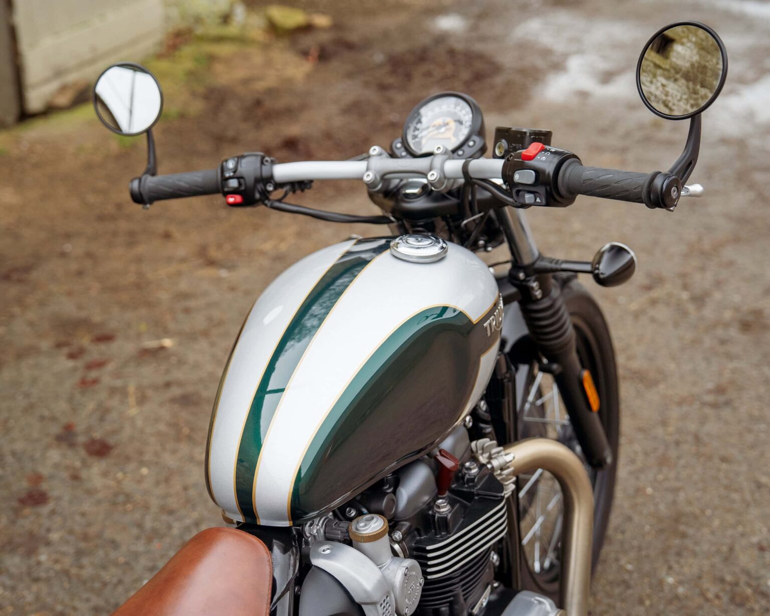 Vintage-style motorcycle with a white and green fuel tank and black frame.