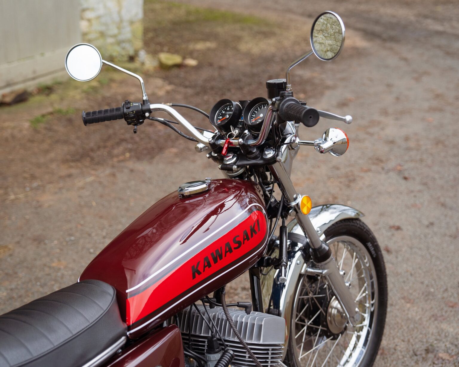 Vintage Kawasaki motorcycle with retro design and chrome details.