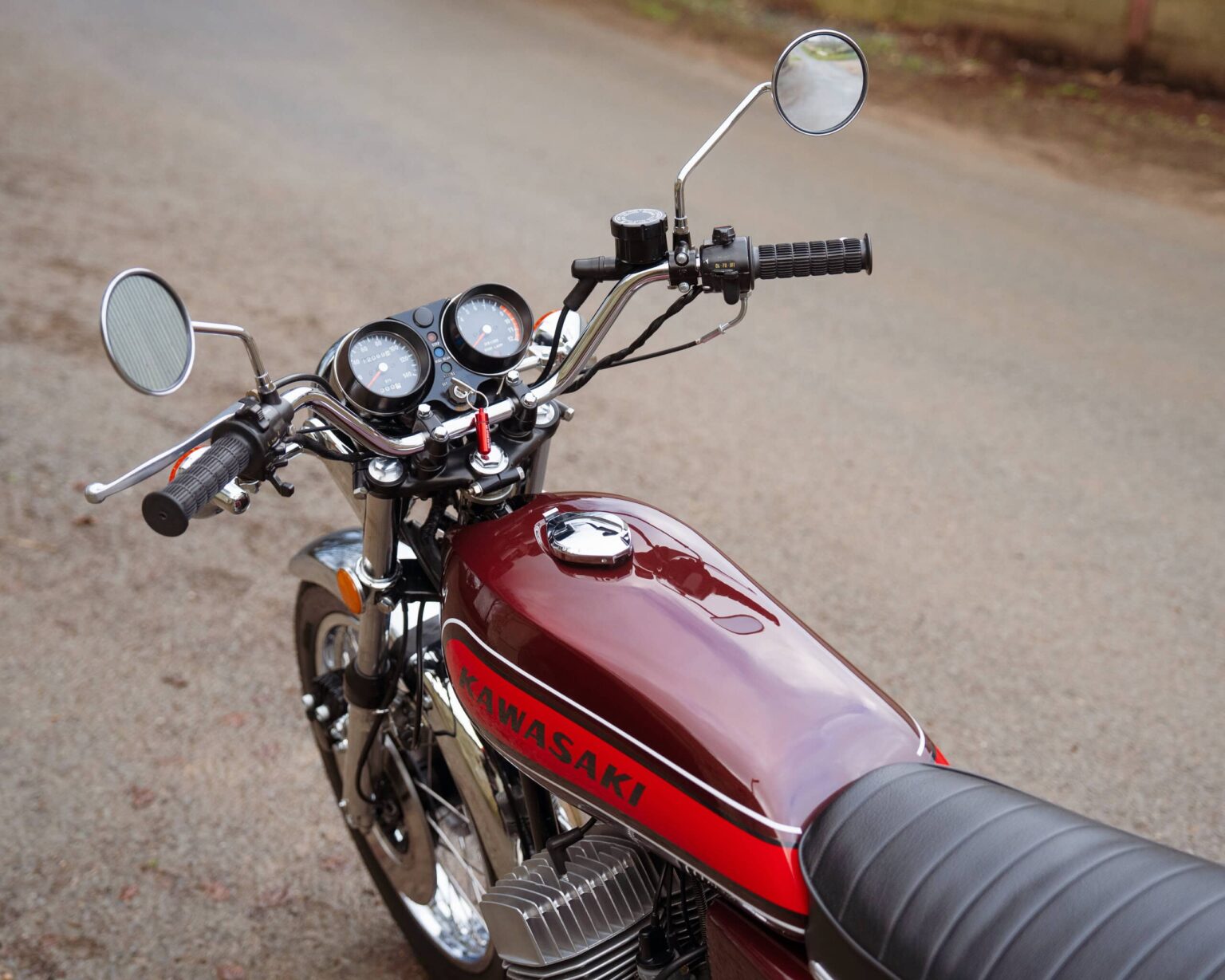 Vintage Kawasaki motorcycle with retro design and chrome details.
