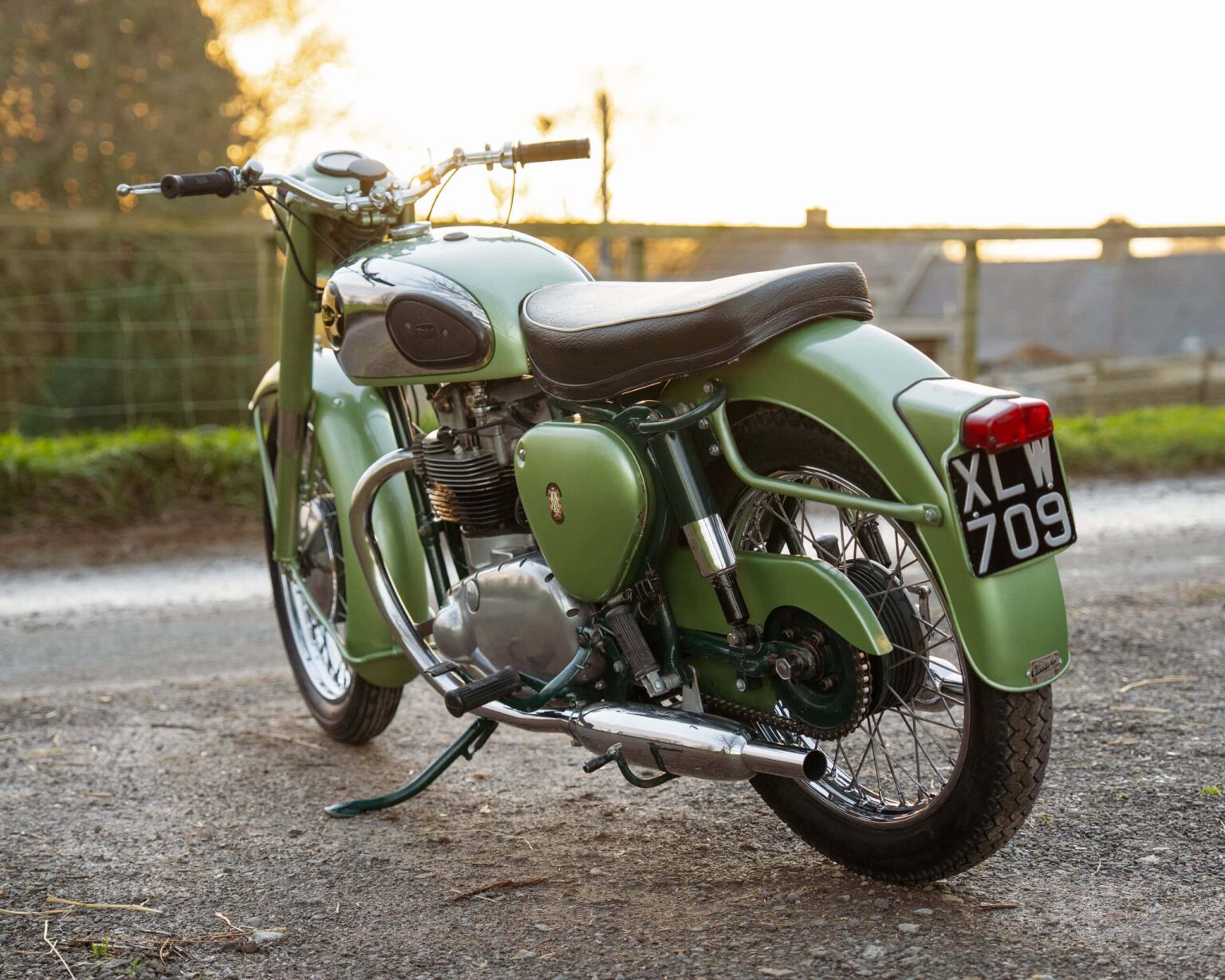 Vintage green classic motorcycle with retro design and chrome details.