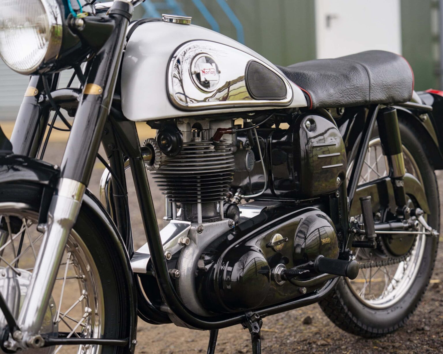 Vintage motorcycle with black and silver finish, detailed engine, and retro design.