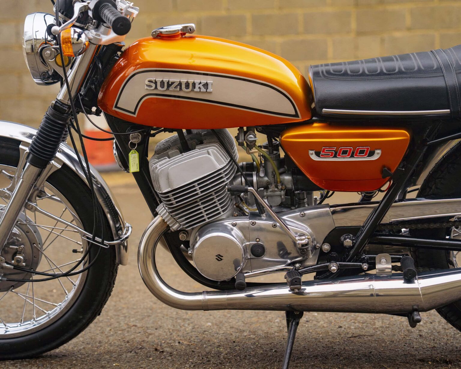 Vintage Suzuki 500 motorcycle with orange and black paintwork.
