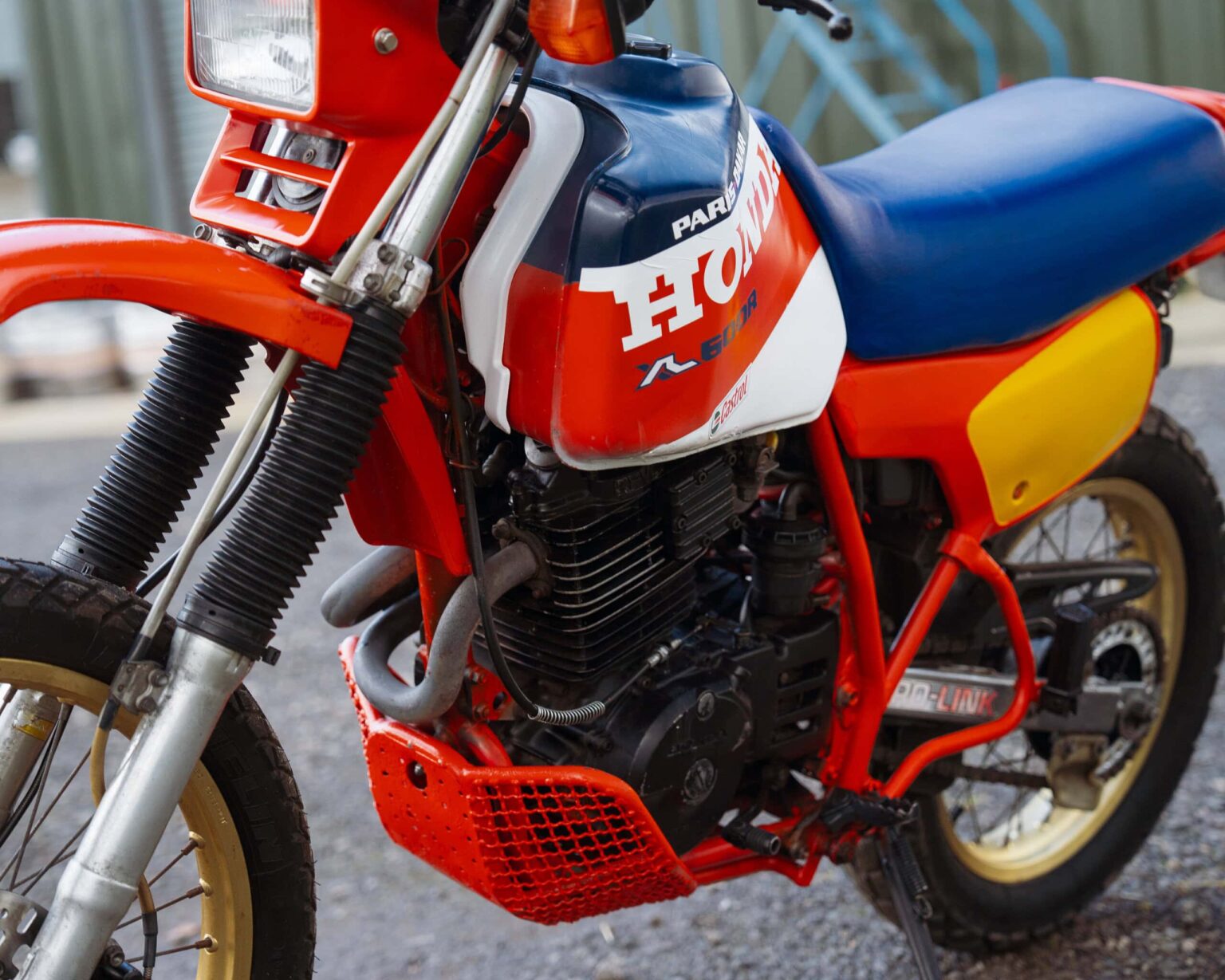 Honda racing motorcycle with vintage design and vibrant colours.